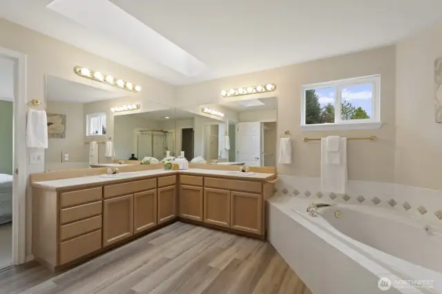 Primary bath includes dual vanities, soaking tub, and separate shower.