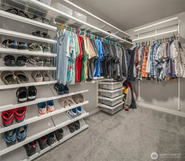 The primary walk-in closet has a custom closet system from the Contaniner Store.