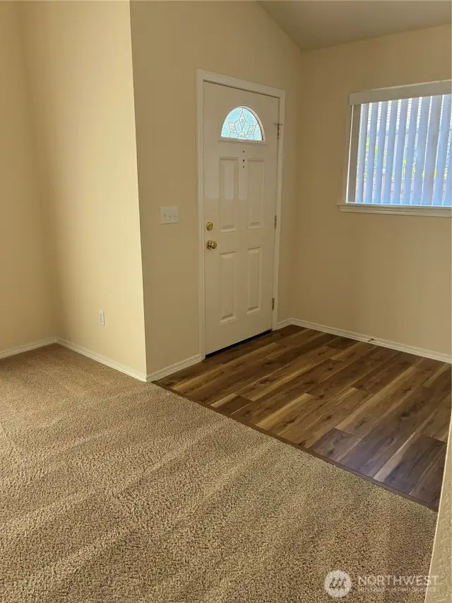 Hard surface floor in entry, then wall to wall