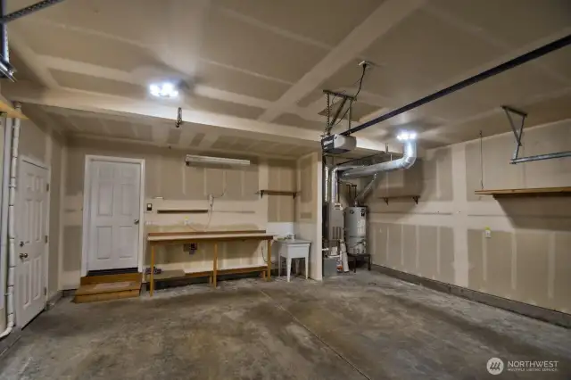 Useful utility sink in garage, work bench and shelving