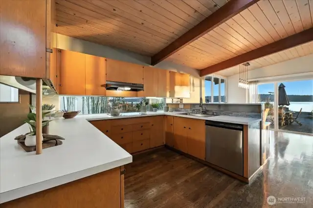 This kitchen is enhanced by the natural light, architectural warmth, and serene setting.
