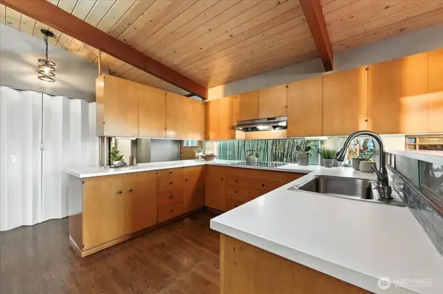 Spacious kitchen with warm, wood cabinetry—offering loads of character and a natural touch. Ample counter space for meal prep and entertaining. Enjoy the smooth electric cooktop for both its sleek look and easy cleanup.