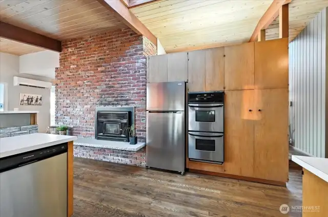 Stylish kitchen with stainless steel appliances, including a double oven, fridge, and whisper-quiet dishwasher.