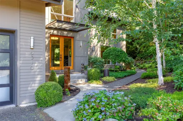 Mature landscaping creates a warm and welcoming entrance.