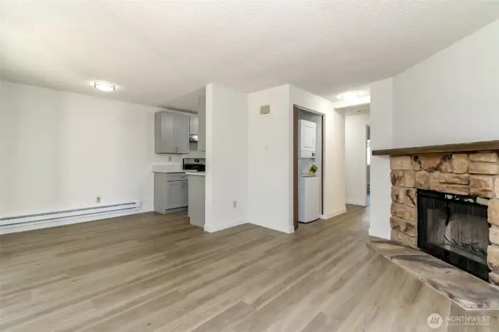 Living Room with Wood Burning Fireplace, Dining Room and Hallway