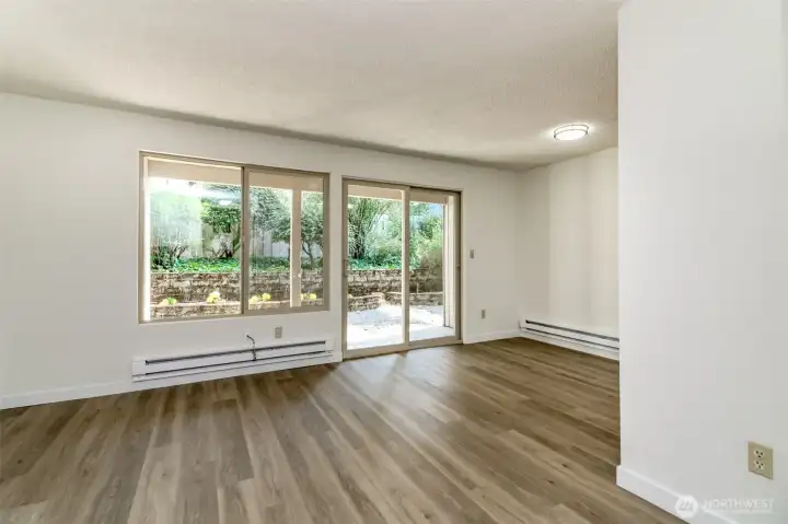 Living Room and Dining Room with Slider Leading Out to Patio