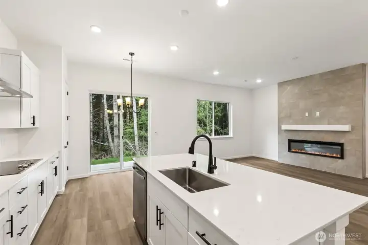 ***Actual Home *** Kitchen and Great room with views to the green area behind home