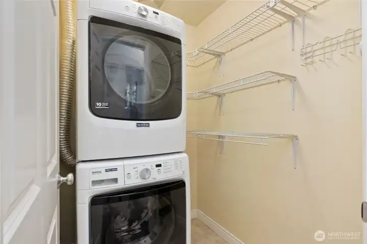 Laundry room with newer Maytag washer and dryer.