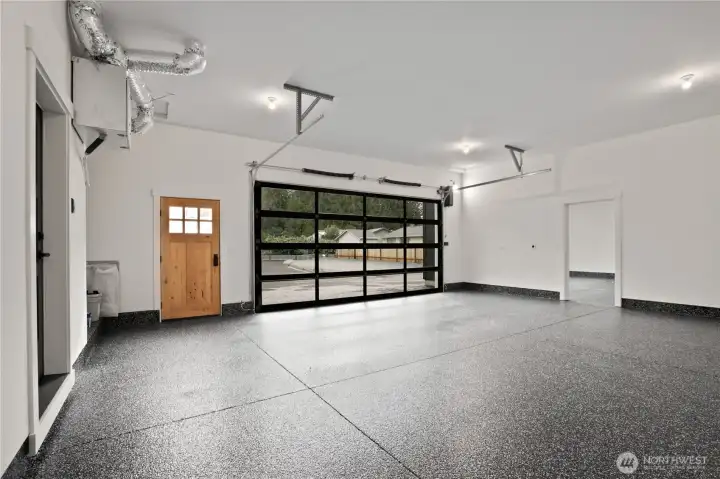 Epoxy garage flooring through main garage as well as adjacent oversized RV bay