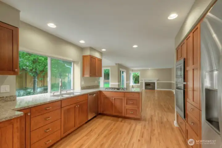 Open-concept kitchen flowing into dining and living areas