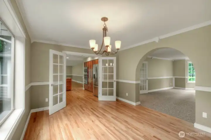 Elegant dining room with French doors and archway, perfect for gatherings