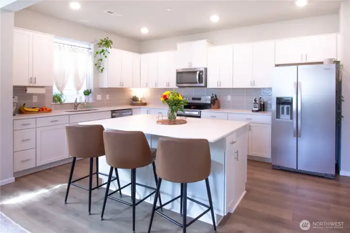 View of kitchen with large island with quarts zounter tops