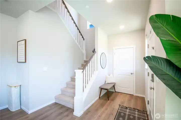 View of the entry way with coat closet and stairs.