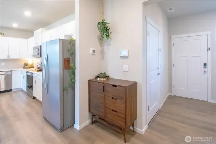 View of the kitchen off to the left as well as garage door and back door off to the right next to the mudroom area.
