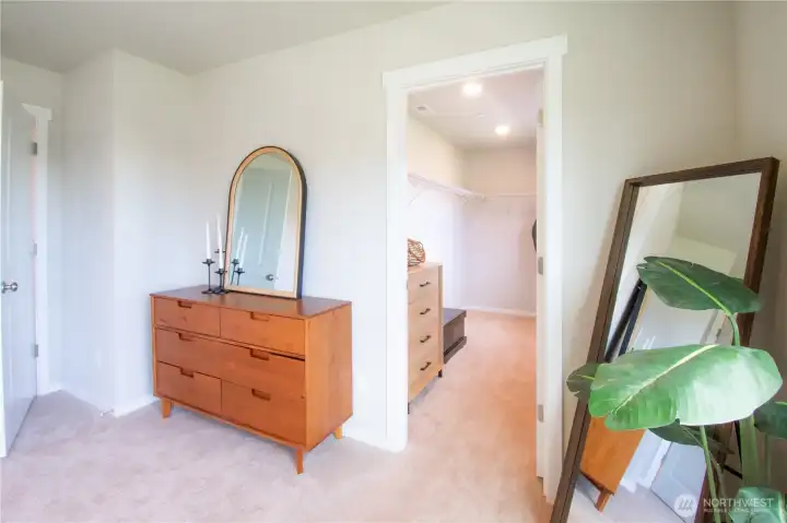 View of primary walk in closet with window from primary bedroom.