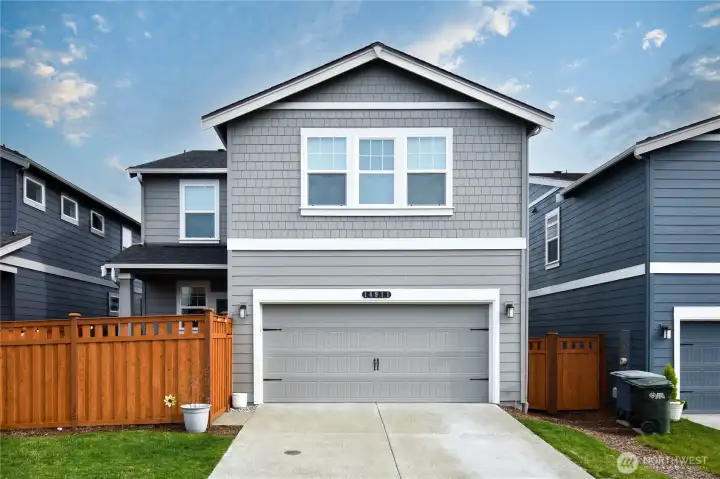 Back of home with 2 car garage access and 2 car driveway.