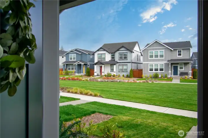 View of shared greenspace with neighbors from front door.