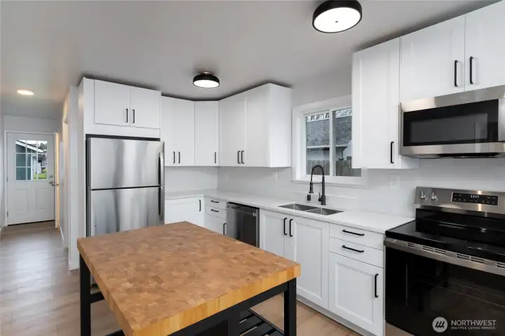 New cabinets and countertops, stainless steel appliances.