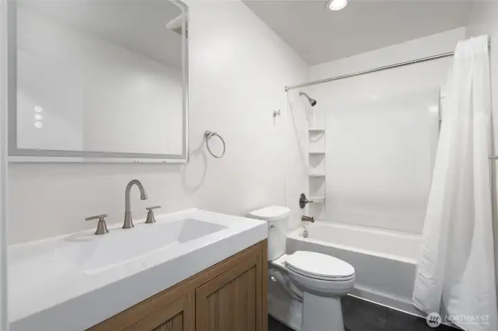 Full bath with LVP flooring, new vanity and fixtures!
