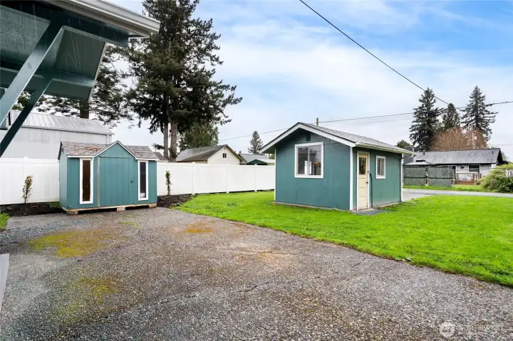 Large level backyard with outbuildings; storage shed and detached one car garage.