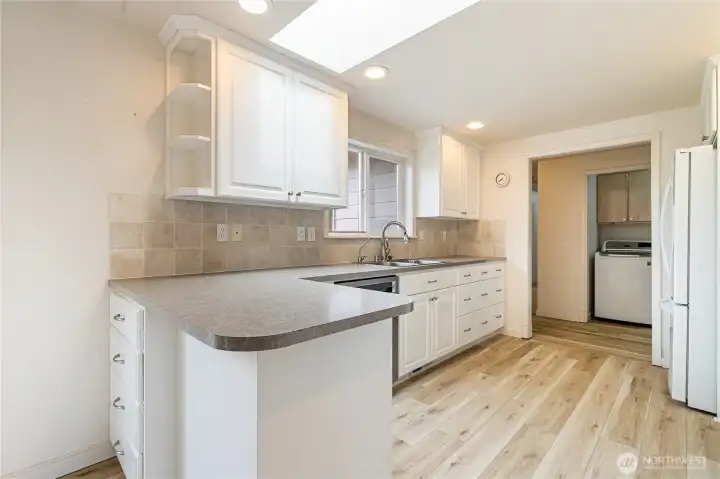 Kitchen has lots of counter top space for cooking and prepping food.