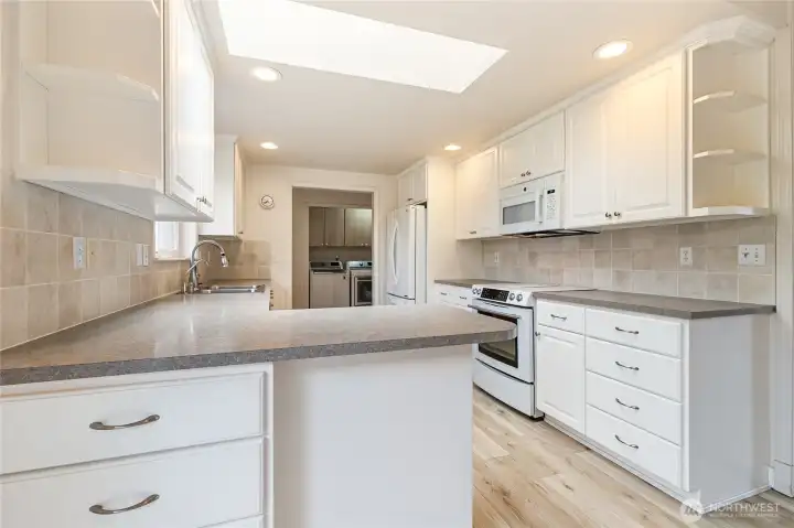 Skylight and window looking to the backyard bring some wonderful light into the kitchen.
