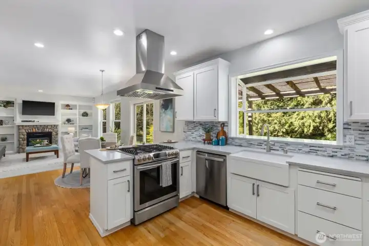 Abundant natural light highlights the expansive countertops and custom white cabinetry, creating a bright and inspiring culinary workspace.