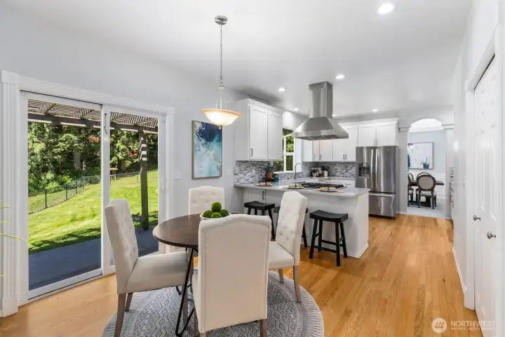 A bright breakfast nook provides the perfect spot for casual daily dining, complete with convenient sliding glass door access to the backyard.