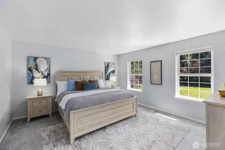 The expansive primary suite is a true sanctuary, offering plush carpeting, neutral tones, and large windows with serene views.