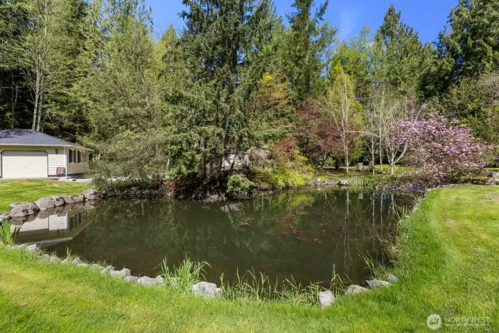 The remarkable property includes a picturesque and tranquil private pond surrounded by lush, mature landscaping.