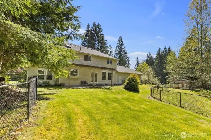 The sprawling, fully fenced backyard offers a massive level lawn with endless possibilities for pets, outdoor recreation and entertaining.