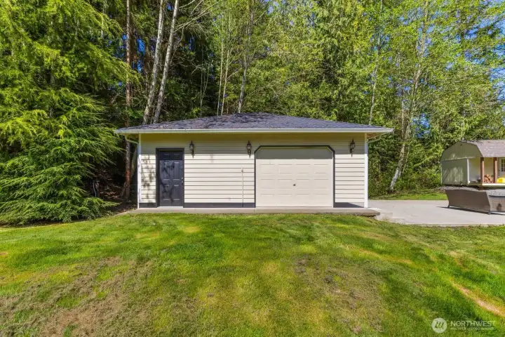 A substantial detached shop is complete with roll-up garage door and heated flex space with 1/2 bath, perfectly matches the home's exterior and provides incredible additional parking, storage, or workshop space.