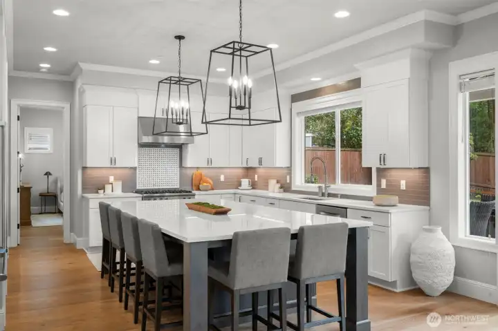 Custom quartz island and designer lighting