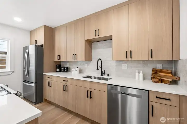 Beautiful quartz countertops and stunning tile backsplash.