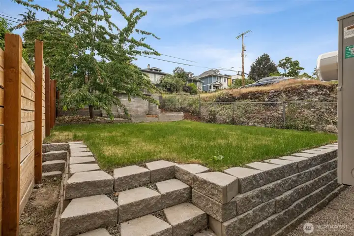 Beautifully landscaped and fully fenced private backyard.