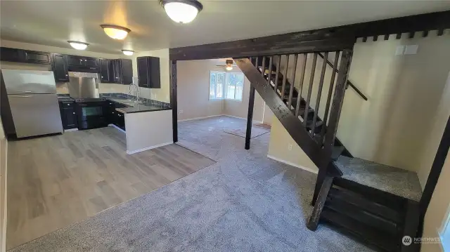 Dining room, kitchen and looking back into living room area