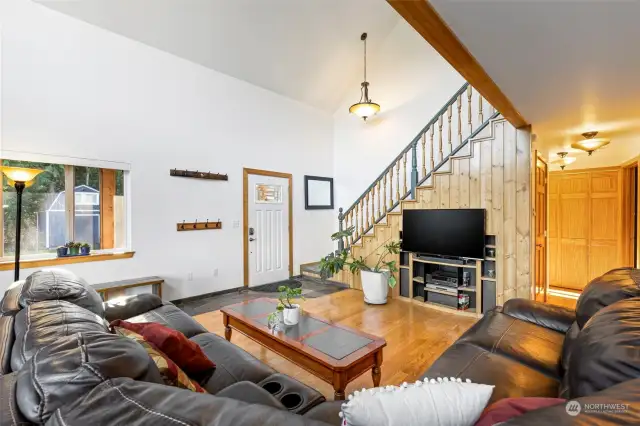 Looking back to the front door from the dining area. Oak floors.  This house can come furnished if you need a turnkey home.