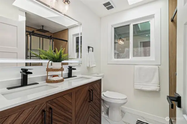 Double Sink Vanity with LED mirror in Master Bedroom with a skylight