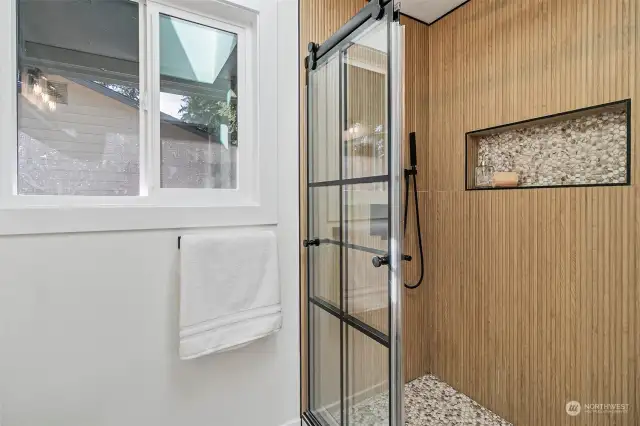 Master bath with Rain Shower, stylish sliding double door and a hidden linen closet at backside of bathroom door