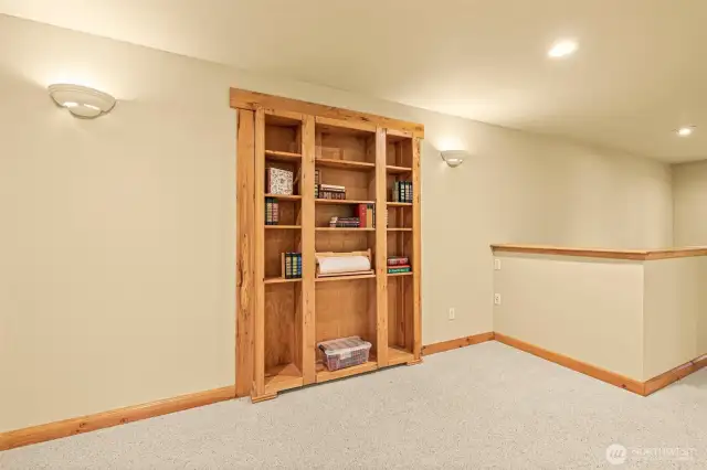 Bookcase in upstairs living room, is entrance to hidden room.