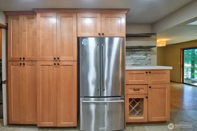 View of the kitchen cabinetry and refrigerator that is included.