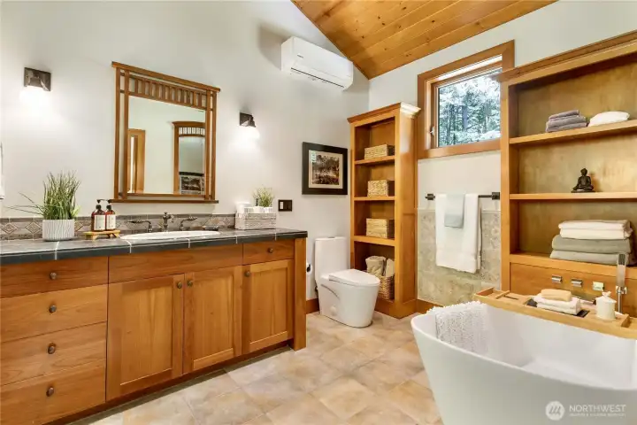 Deep soaking tub is a great addition to this spa-like bathroom.