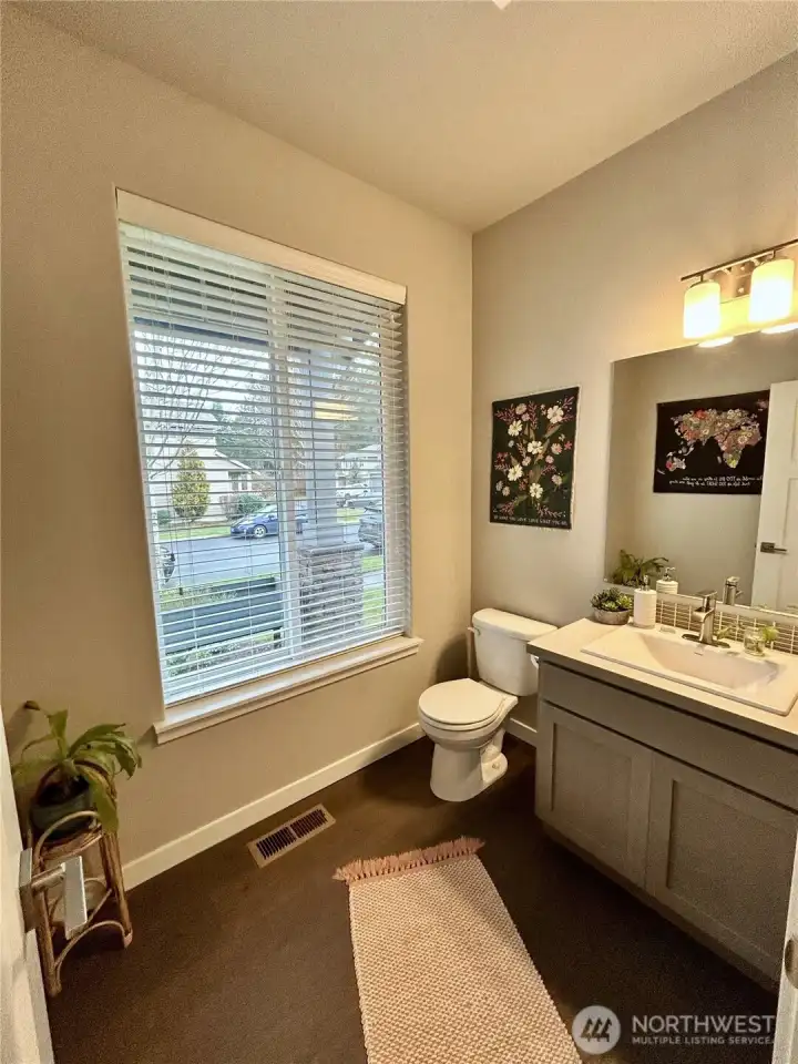 Main floor 1/2 bath just off entry with hardwood floors.