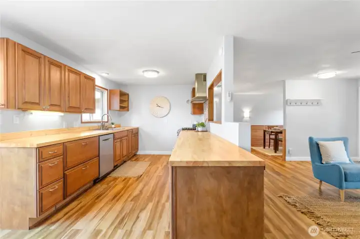 Kitchen features new butcher block counters and hardwood cabinets