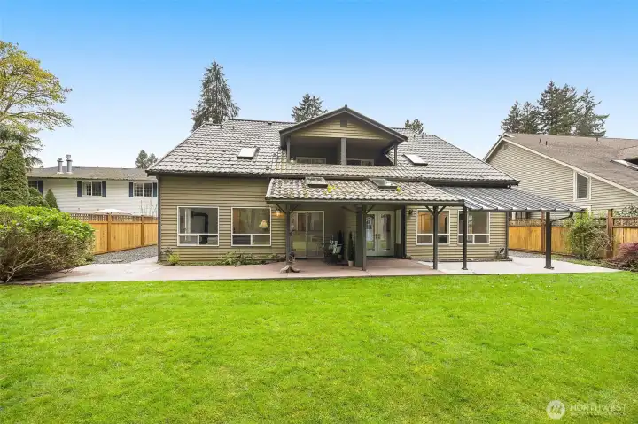 Backyard full landscaped with covered deck