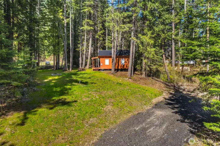 featuring a temporary cabin-style structure and established fire pit