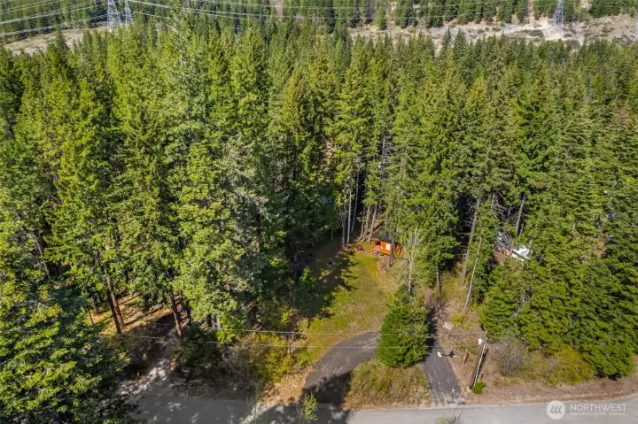 The lot provides a strong blueprint—set back from the road for privacy, with ample space to expand while maintaining a peaceful, wooded buffer.