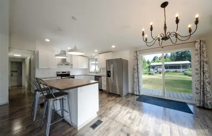 Kitchen sliding glass door leading to back yard garden