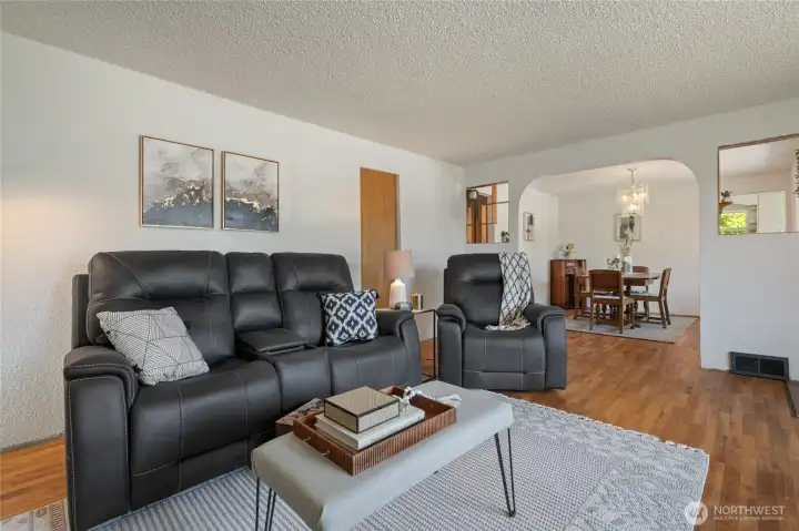 Living room flows into the dining room. Notice the lovely coved arches.