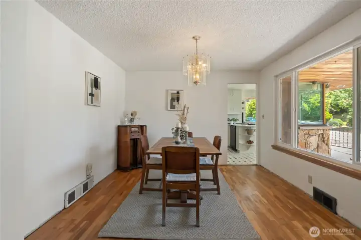 Large dining room with natural light from huge picture windows. There is a pocket door between the dining room & kitchen.